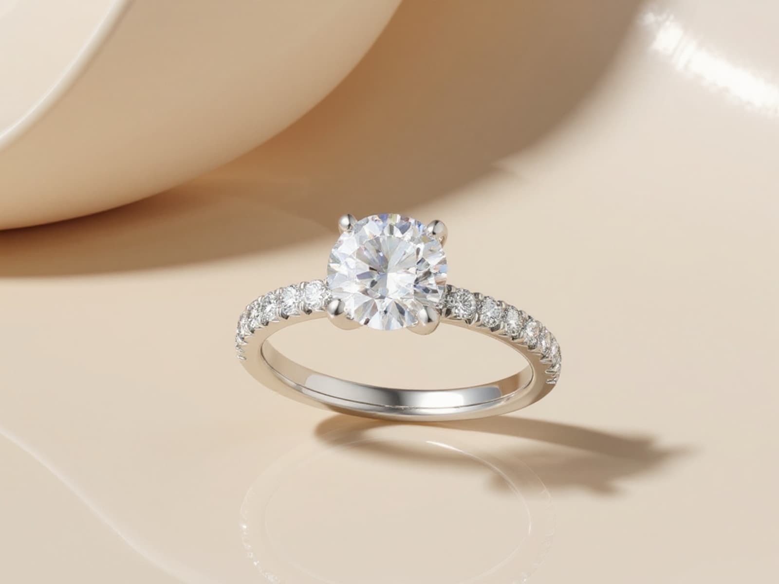 The same diamond reset into a modern white-gold round solitaire with pave shoulders